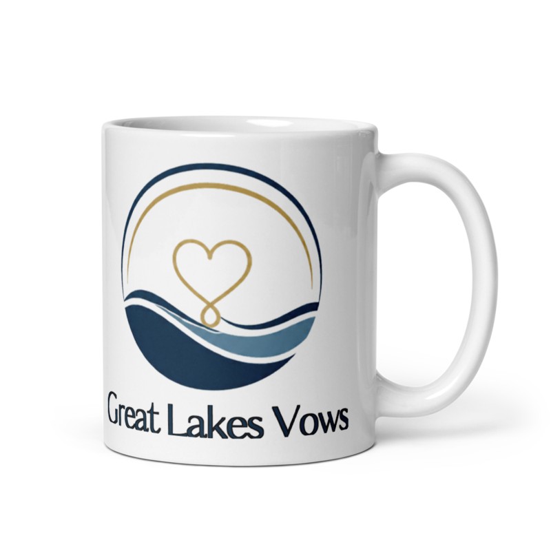 White mug with the Great Lakes Vows logo — a round navy and gold badge with a heart over lake waves and the wordmark below — in a clean front-facing product photo