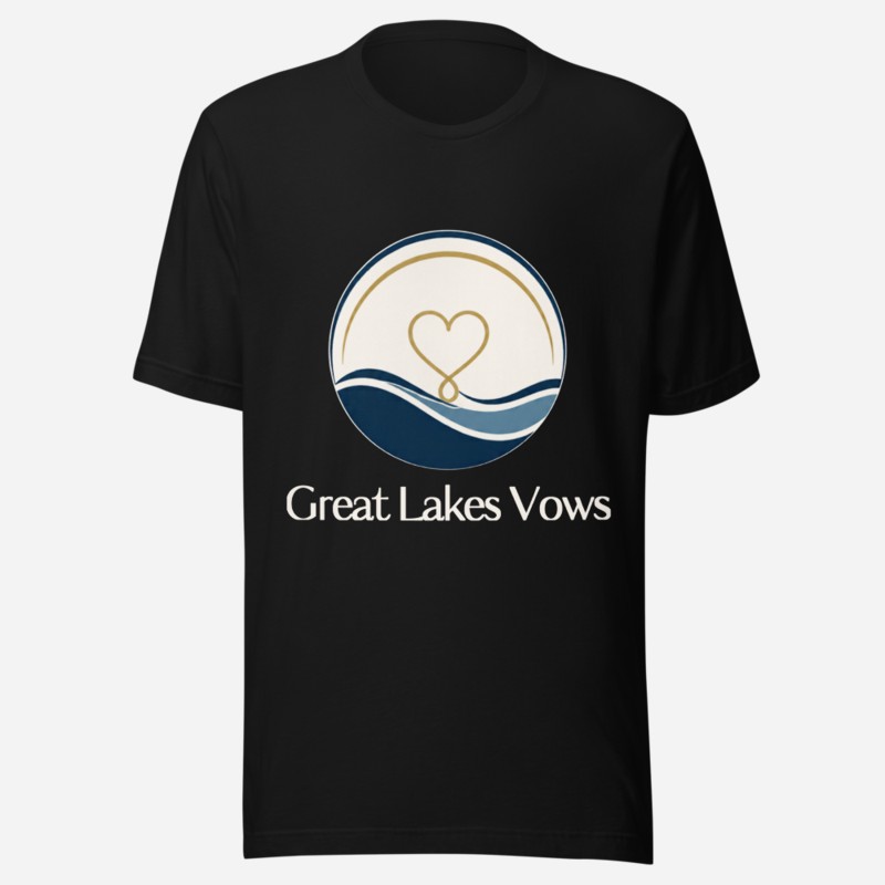Front of a black tee with the Great Lakes Vows logo — a round navy and gold badge with a heart over lake waves and the wordmark below — centered on the chest